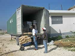 Men at the orphanage unloading the container