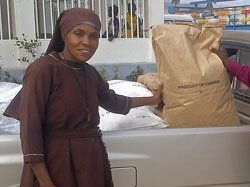 Sister Claire Irene receiving supplies by local truck